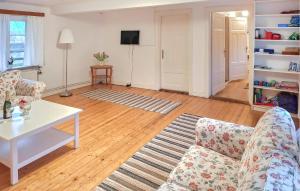 a living room with a couch and a table at Gorgeous Home In Blentarp With Wifi in Blentarp