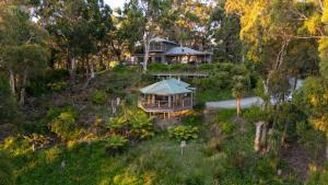 an aerial view of a house on a hill with trees at Beacon Point Ocean View Villas in Apollo Bay