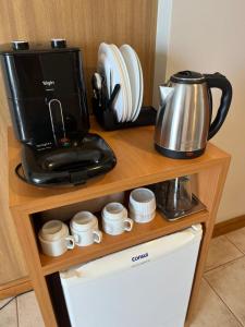 a coffee maker on top of a wooden shelf at Flat Tropical Hotel Com Varanda Vista Espetacular in Manaus