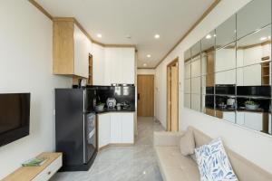 a kitchen and living room with a black refrigerator at KOA Apart Hotel Phu Quoc in Phú Quốc +57 photos