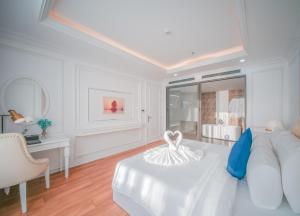 a white room with a bed and a couch at Sea Soul Hotel in Nha Trang