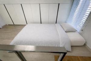 a bedroom with a white bed and a table at Arbo Unit in Seoul +25 photos