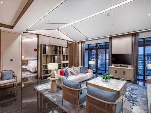 a living room with a couch and a table at Steigenberger Hotel Chongqing in Chongqing