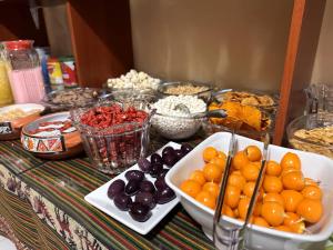 a table topped with bowls of fruit and other food at Cusco - Flor de Loto in Cusco