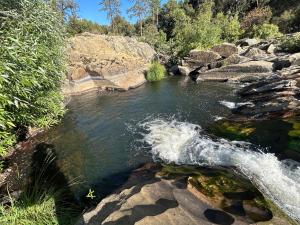 a stream of water with rocks in a river at Cedar Springs Retreats in North Fork