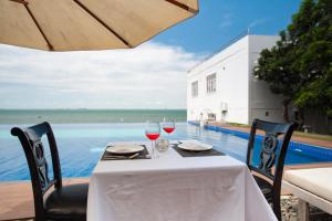 een tafel met twee glazen rode wijn op een terras bij SV Boutique Resort in Vung Tau +39 foto's