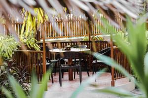 a table and chairs in a restaurant with plants at Hello Ocean View in Funadhoo