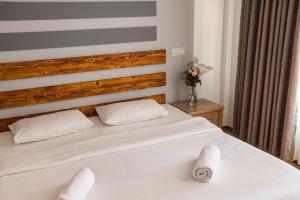 a bedroom with a white bed with white towels on it at Hello Ocean View in Funadhoo
