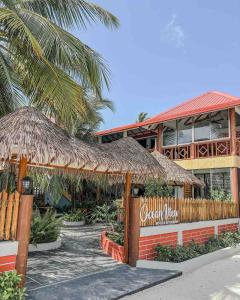 a restaurant with a sign in front of a building at Hello Ocean View in Funadhoo