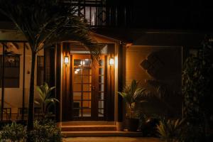 a front door of a house at night at Hello Ocean View in Funadhoo +1 photo