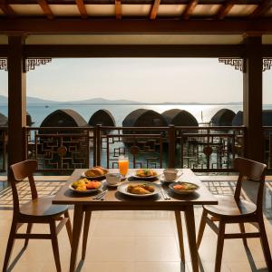 a table with plates of food on top of a balcony at PULAU LIMA Resort in Serang