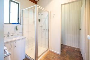 a bathroom with a shower and a sink at Beacon Point Ocean View Villas in Apollo Bay +178 photos