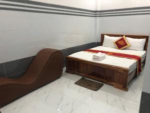 a small bedroom with a bed and a chair at nhà nhỉ phát thành in Kon Rung (1)