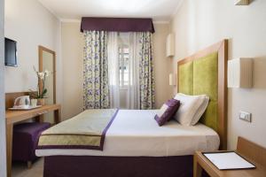Postel nebo postele na pokoji v ubytování Hotel Perseo