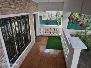 a balcony with a bench and some plants at Sunshinee Villa in Pune