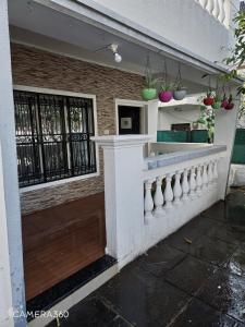a building with a wall with vases on it at Sunshinee Villa in Pune