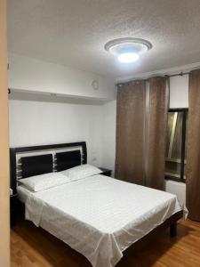 a bedroom with a large white bed in a room at JARDIN DE TEQUENDAMA HOTEl in Cali