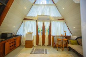 a living room with a small table and a window at River Bend Nook in Ahangama