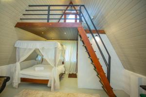a attic room with a bed and a staircase at River Bend Nook in Ahangama