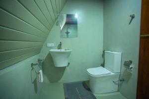 a small bathroom with a sink and a toilet at River Bend Nook in Ahangama +7 photos