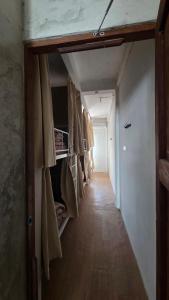 a hallway with several bunk beds in a room at Zanit Hostel in Don Muang Airport