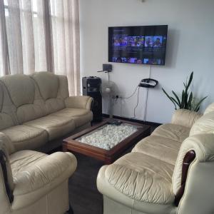 a living room with two couches and a coffee table at Hatton Nottingham Villa in Hatton