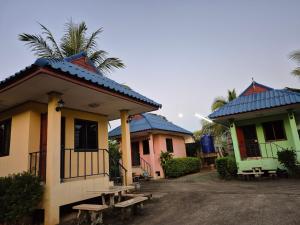 a group of three houses with blue roofs at Panna Kalong in Chiang Khong