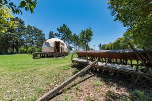 a tent and a boat in a field at El Encuentro Casa de Campo in Río Cuarto