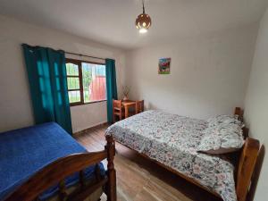 a bedroom with two beds and a window at La Posta de Don Calixto in León