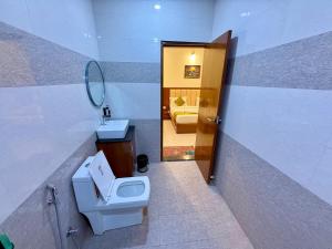 a bathroom with a toilet and a sink and a mirror at New Crown Plaza in Jodhpur +39 photos