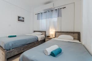 a bedroom with two beds with towels on them at Seaview Sanctuary House in Larnaca