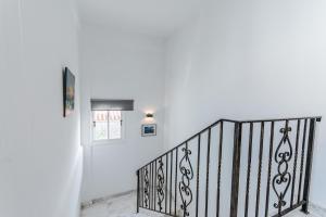 a staircase with a black railing in a house at Seaview Sanctuary House in Larnaca