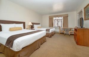 a hotel room with two beds and a television at The Baroness Hotel in Seattle +37 photos