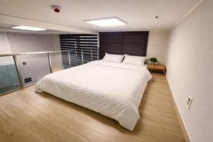 a bedroom with a large white bed in it at Arbo Unit in Seoul