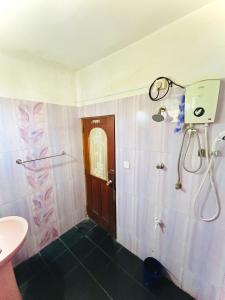 a bathroom with a shower and a sink at Zandeepa Homestay in Ahungalla