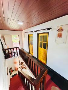 a room with a wooden staircase with windows at Zandeepa Homestay in Ahungalla