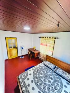 a bedroom with a large bed and a wooden ceiling at Zandeepa Homestay in Ahungalla