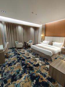 a hotel room with a large bed and a large rug at فندق بوابة ابها in Khamis Mushayt