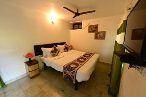 a bedroom with a bed in a room at Perth villa in Mount Ābu