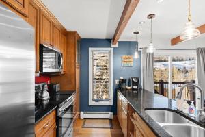 a kitchen with black countertops and a window at Woodbridge 21C in Snowmass Village
