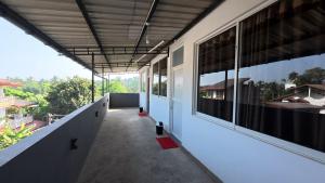 an empty hallway of a building with windows at Shehan's Hotel Maharagama in Maharagama +22 photos