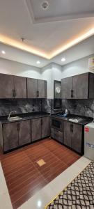 a kitchen with wooden floors and stainless steel cabinets at سهول بارك in Riyadh