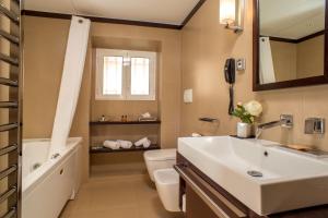 a bathroom with a sink and a tub and a toilet at Les Fleurs Luxury House in Rome +52 photos