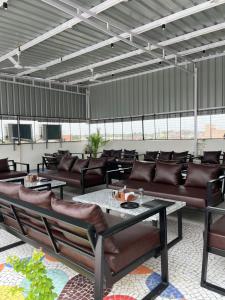 a patio with couches and a table and chairs at New Crown Plaza in Jodhpur