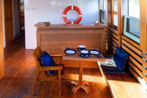 a small table with two chairs and a mirror at Sehat Elona Adventure in Lombok