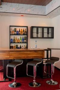 a bar with two bar stools in a room at Hatton Nottingham Villa in Hatton