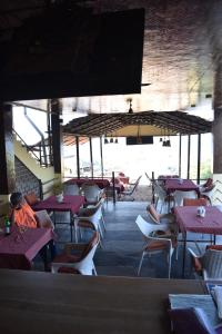 a dining room with tables and chairs and a tv at Sea view Sun shine in Calangute