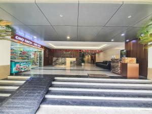 a lobby of a shopping mall with a staircase at Little House Sea in Nha Trang