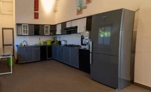 a large kitchen with a refrigerator in a room at Hatton Nottingham Villa in Hatton +17 photos