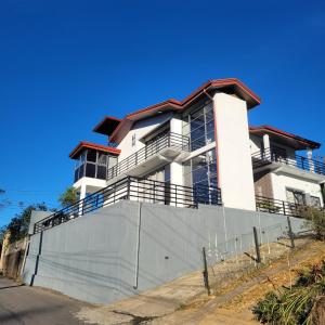 a white building with a fence in front of it at Hatton Nottingham Villa in Hatton